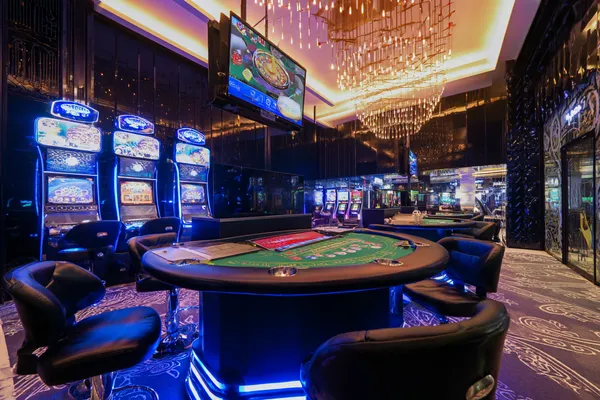 A confident dealer surrounded by casino chips inviting players to access their PANALO account, reflecting quick and easy login options.